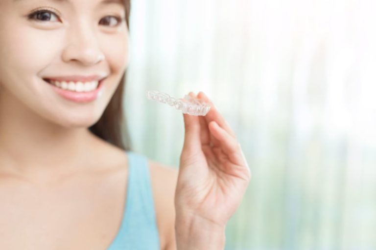 patient holding clear aligners beaverton or