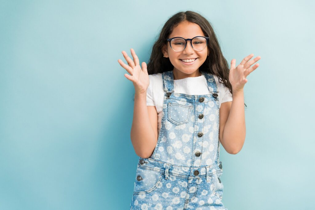 Smiling young girl around the age recommended for a first orthodontic check